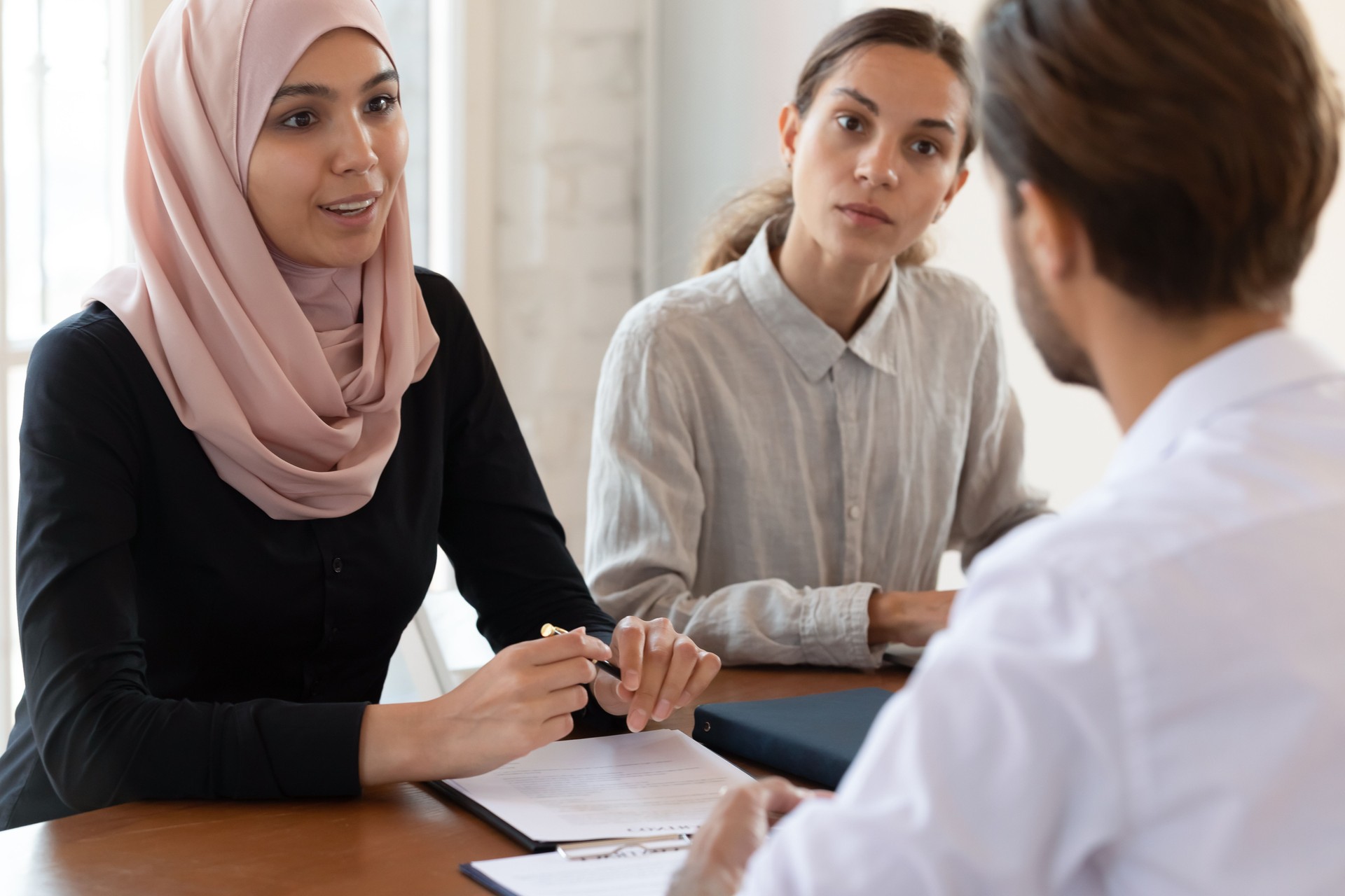 Middle eastern ethnicity businesswoman discussing commercial deal with company client